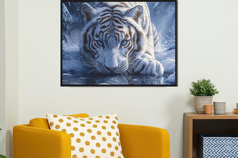 May include: A white tiger with blue eyes stares intensely at the viewer. The tiger is lying in a snowy forest setting with a reflection of the tiger in the water below.