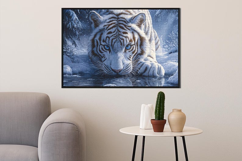 May include: A white tiger with blue eyes stares intently at the viewer. The tiger is lying in a pool of water with a snowy background.