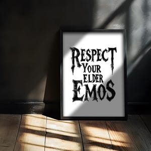 Può includere: Stampa incorniciata in bianco e nero con il testo "Respect Your Elder Emos" in un font stilizzato.