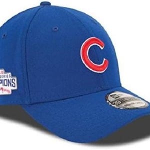 May include: A blue baseball cap with a red and white "C" logo on the front. The cap has a "2016 World Series Champions" patch on the side.