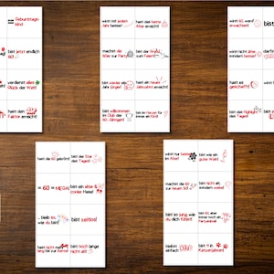 May include: A set of 20 printable cards with red and black text on a white background. The cards feature humorous sayings about turning 60. The text includes phrases like "bist 60", "hast den VIP Faktor erreicht", "bist zeitlos", and "bist eine lebende Legende!"