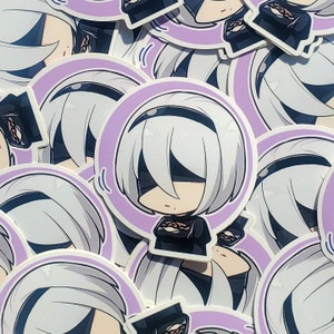 May include: A set of stickers featuring a cartoon character with white hair and a black eye patch. The character is wearing a black and white outfit and is holding a small, round object. The stickers are on a purple background with a white border.