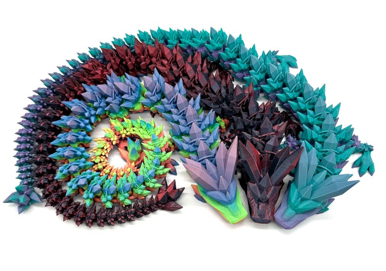 May include: A colorful set of 3D printed dragon heads with a crystal-like texture. The heads are arranged in a spiral pattern and are made in a variety of colors, including purple, blue, green, and red.