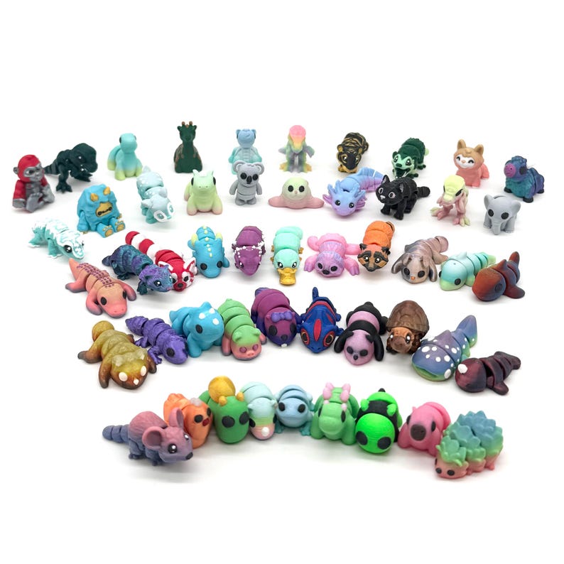 May include: A collection of colorful, hand-painted miniature animal figurines. The figurines are made of polymer clay and feature a variety of animals, including cats, dogs, birds, and insects.
