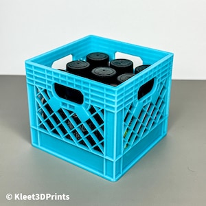 May include: A bright turquoise plastic crate filled with several black bottles. The crate has a grid-like design with rectangular openings on the sides. The bottles have black caps. The text "© Kleet3DPrints" is visible in the bottom left corner.