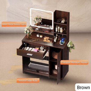 May include: A brown vanity table with a lighted mirror, drawers, and shelves. The vanity has a 4mm thick safety glass mirror and smooth slide rails. It features a 7-shaped hairdryer holder and is filled with makeup and accessories. The word "Brown" is visible.