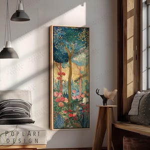 May include: A framed vertical art print featuring a stylized forest scene. The artwork showcases a central tree with a golden trunk, surrounded by blue foliage and colorful flowers in shades of pink and red. The frame is a light brown color.