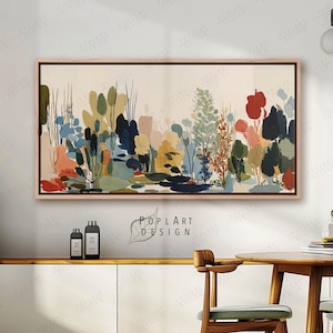 Peut inclure: Peinture de paysage abstrait dans un cadre en bois. L'œuvre présente un éventail coloré de plantes et de fleurs stylisées dans des tons de vert, de bleu, de rouge et de jaune. La peinture est exposée sur un mur blanc.