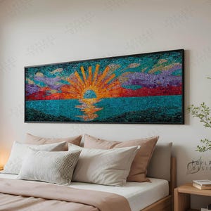 May include: A mosaic artwork of a sunset over the sea, framed in black. The artwork uses a vibrant colour palette of orange, yellow, blue, purple, and red. The mosaic is displayed above a bed with pillows and a wooden bedside table.
