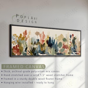 May include: Framed canvas art featuring an abstract floral design in a rectangular shape. The artwork showcases a variety of colorful brushstrokes in shades of red, blue, green, and yellow. The canvas is framed in a black floater frame.