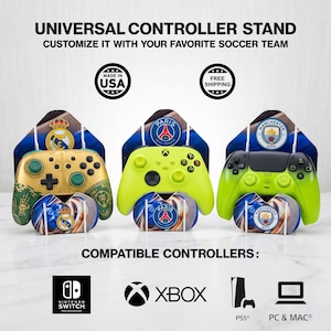 May include: Universal controller stands customized with soccer team designs. The image shows three stands with controllers, each featuring a different team logo. Compatible with Nintendo Switch, Xbox, PS5, and PC & Mac.