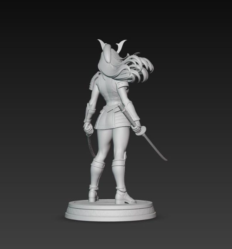 May include: A gray 3D-printed figurine of a female warrior, viewed from the back. She wears armor, a helmet, and a short skirt, holding a sword and a chain weapon. The figure stands on a circular base against a dark background.