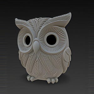 May include: A light gray owl figurine with detailed feather and eye designs. The owl has large, round eyes and a beak. The figurine is made of a solid material and has a textured surface. The owl is a decorative item.