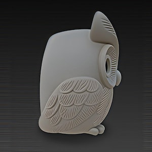 May include: A light gray owl figurine with detailed feather and eye designs. The owl is in a side profile, showcasing its wing and head features. The figurine has a smooth, matte finish and is set against a dark gray background.
