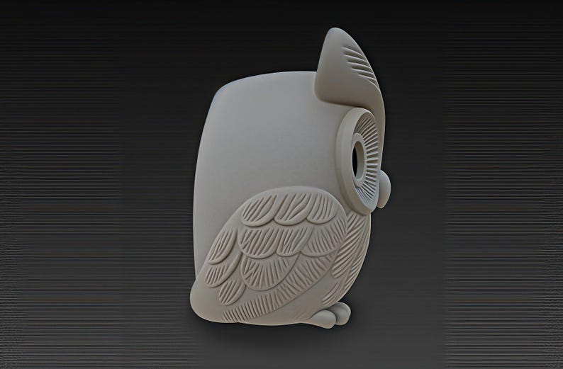 May include: A light gray owl figurine with detailed feather and eye designs. The owl is in a side profile, showcasing its wing and head features. The figurine has a smooth, matte finish and is set against a dark gray background.