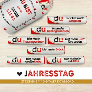 May include: A selection of white and red candy bars with German text, including phrases like "Du bist meine große Liebe" and "Du machst mich komplett." The image also features the text "JAHRESTAG" and "27 DESIGNS *** DIGITALER DOWNLOAD."