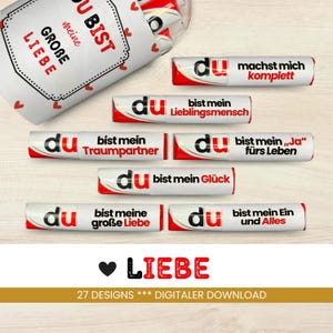 May include: A set of 27 printable designs for chocolate bar wrappers. Each wrapper features a red heart and the word "du" in white, with a different romantic message in German. The designs include phrases like "Du bist mein Traumpartner" and "Du bist mein Glück".