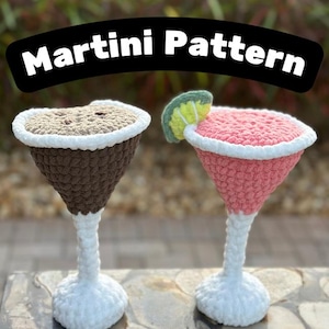 May include: Two crocheted martini glasses, one brown and one pink, with a white crocheted stem and base. The pink martini glass has a lime garnish.