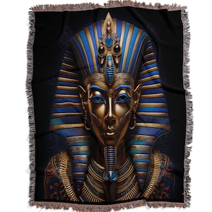 May include: A gold and blue woven tapestry featuring a detailed illustration of an Egyptian pharaoh wearing a traditional headdress.