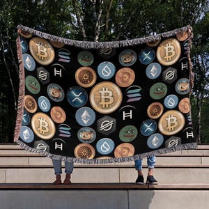 May include: A black woven throw blanket with a repeating pattern of various cryptocurrency logos, including Bitcoin, Ethereum, Dogecoin, and Shiba Inu. The logos are in various colors, including gold, silver, blue, and green.