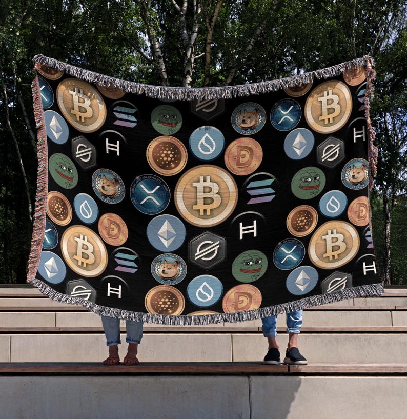 May include: A black woven throw blanket with a repeating pattern of various cryptocurrency logos, including Bitcoin, Ethereum, Dogecoin, and Shiba Inu. The logos are in various colors, including gold, silver, blue, and green.