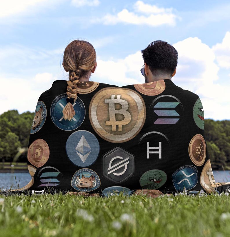 May include: A black fleece blanket with a variety of colorful cryptocurrency logos printed on it. The logos include Bitcoin, Ethereum, Dogecoin, and more.