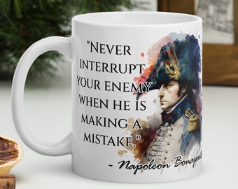 May include: White ceramic coffee mug with a watercolor illustration of Napoleon Bonaparte. The mug features a quote from Napoleon: "Never interrupt your enemy when he is making a mistake."