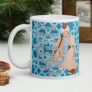 May include: White ceramic mug with a blue and white design featuring a quote by Rumi: "A Candle never Loses any of its Light while Lighting up another candle." -Rumi