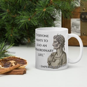 May include: White ceramic mug with a black and white image of Emperor Augustus and a quote that reads "Everyone wants to lead an extraordinary life." - Emperor Augustus