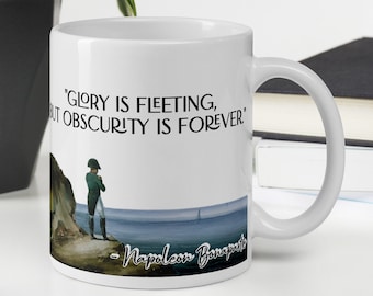 May include: White ceramic coffee mug with a black and white image of Napoleon Bonaparte and a quote that reads "Glory is fleeting, but obscurity is forever."