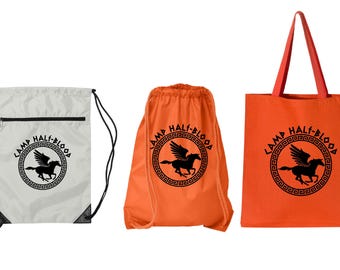 May include: Three different bags with the Camp Half-Blood logo. The logo is a black winged horse inside a circle with the words "Camp Half-Blood" around it. The bags are a white drawstring bag, an orange drawstring bag, and an orange tote bag.