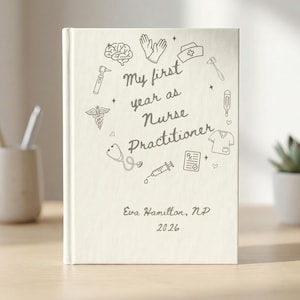 May include: A cream-colored journal with the text "My first year as Nurse Practitioner" and medical-themed illustrations. The name "Eva Hamilton, NP" and the year "2026" are also printed on the cover.
