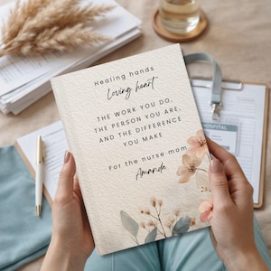 May include: A personalized notebook with the text "Healing hands, Loving heart" and a floral design. The notebook's message reads, "The work you do, the person you are, and the difference you make. For the nurse mom, Amanda."
