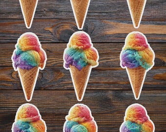 May include: Nine stickers of rainbow-colored ice cream cones. Each cone has three scoops of ice cream in shades of red, orange, yellow, green, blue, and purple. The cones are a light brown color and have a waffle texture.