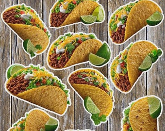 May include: A collection of sticker-style images of tacos, each filled with seasoned ground meat, shredded cheese, lettuce, and other toppings. Each taco is accompanied by a lime wedge. The background is a wooden surface.