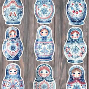 May include: Nine Russian nesting dolls with watercolor designs in shades of blue, red, and white. Each doll features a unique floral or snowflake pattern and a painted face. The dolls are arranged on a wooden background.