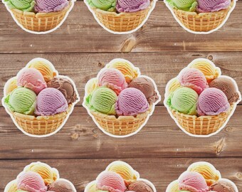 May include: Nine colorful ice cream scoops in a waffle basket, arranged on a wooden background. The ice cream flavors include green, pink, purple, brown, and yellow. The baskets are outlined in white.