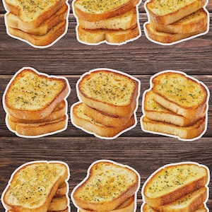 May include: Nine sticker cutouts of toasted garlic bread slices, golden brown with visible herbs. The bread is stacked in small piles, with a wooden background.