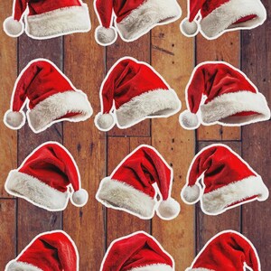 May include: A collection of red Santa hats with white faux fur trim and a white pom-pom. The hats are arranged on a wooden background, creating a festive holiday theme. The hats are a classic Christmas accessory.