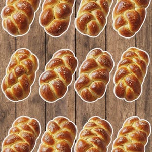 May include: Twelve golden-brown challah loaves, braided and sprinkled with sesame seeds, are arranged on a wooden background. The bread has a glossy finish, suggesting a fresh bake. The image showcases a traditional Jewish bread.