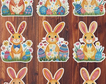 May include: Nine Easter bunny stickers with colorful designs. Each sticker features a cartoon bunny with long ears, a bow tie or bow, and a floral or egg-themed pattern. The bunnies are surrounded by flowers and decorated Easter eggs.