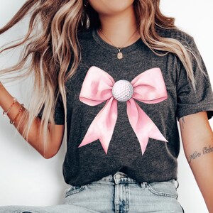Golf girl png, Coquette golf, Golf ball png, Golf girly, Pink golf png, Golf lover png Golf mama png, Golf mom png, Golf png, Preppy png, Sports png, golf ball bow, golf shirt png
Coquette golf girl PNG with pink golf, preppy sports style, golf ball bow, and golf mom designs, perfect for golf lovers and shirts!