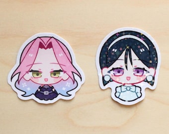 May include: Two cartoon character stickers with a sparkly background. The sticker on the left features a pink-haired character with blue and white accents. The sticker on the right features a black-haired character with a blue and white dress.