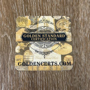 Puede incluir: Una tarjeta cuadrada de Golden Standard Certification con esquinas redondeadas, que presenta un collage en tonos dorados de recuerdos deportivos y firmas. El texto dice Golden Standard Certification y Goldencerts.com en letras negras.