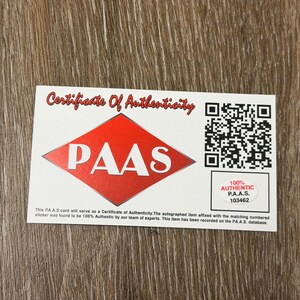 May include: A white Certificate of Authenticity card with red accents. The card features the text "Certificate Of Authenticity" and the PAAS logo. Includes a QR code and the text "100% AUTHENTIC P.A.A.S. 103462".