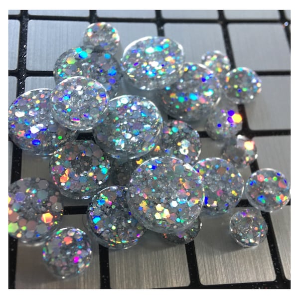 Unique buttons made of epoxy resin with silver holographic glitter insertion. Several sizes available.