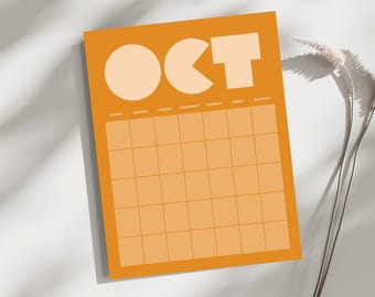 May include: Orange monthly calendar with the month of October displayed in large, white, geometric shapes. The days of the week are listed across the top, and the calendar grid is below. A sprig of dried flowers is in the background.
