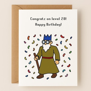 May include: A birthday card with a cartoon wizard illustration and the text "Congratz on level 28! Happy Birthday!". The wizard wears a blue crown, glasses, and a long robe, surrounded by colorful confetti.