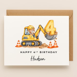 May include: A white greeting card featuring a cartoon teddy bear in a yellow hard hat operating a yellow excavator. The excavator bucket lifts a large yellow number 4. Three orange traffic cones sit on the ground. Text reads HAPPY 4th BIRTHDAY Hudson.