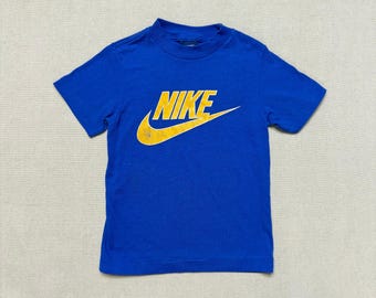 blue and yellow nike shirt